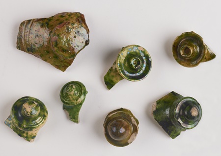 Knops of money pots that were found during the excavation of the Rose Theatre.  