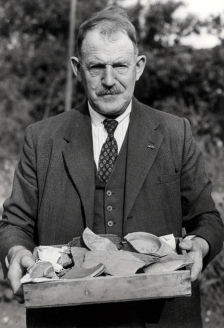A Mr A. Eldridge with one of many trays of finds from the site.  (©Museum of London)