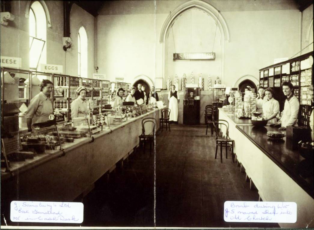 Second World War ‘shop in a church’
Interior of the East Grinstead shop in church with staff. This branch was temporarily moved into a disused church after a bomb hit the shop building during WWII. (ID no.: SA/WAR/2/2/2)
