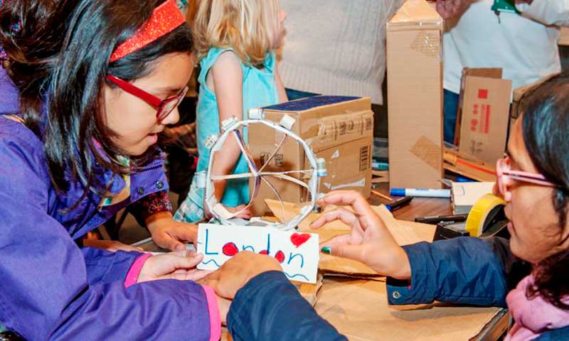 A mother and daughter creating a London landmark in cardboard during a museum families session.